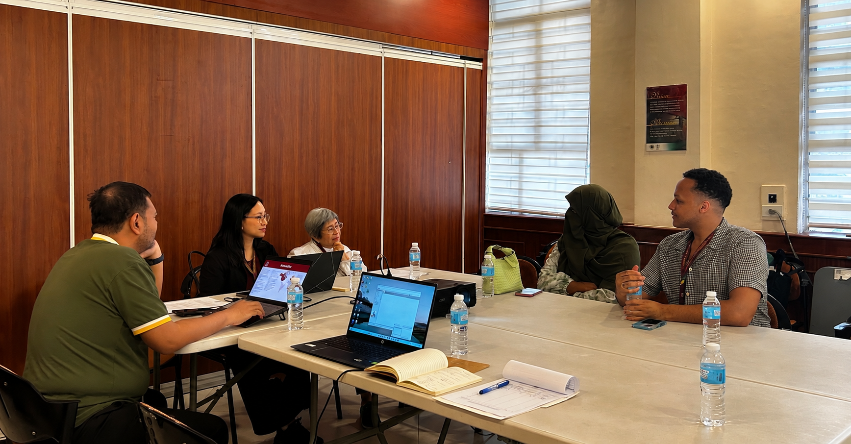 NIH representatives and visiting students engage in a discussion.